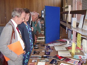 Pam is discusssing the exhibits with the Mayor.